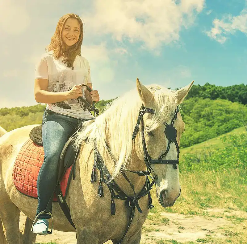 girl riding a palomino horse